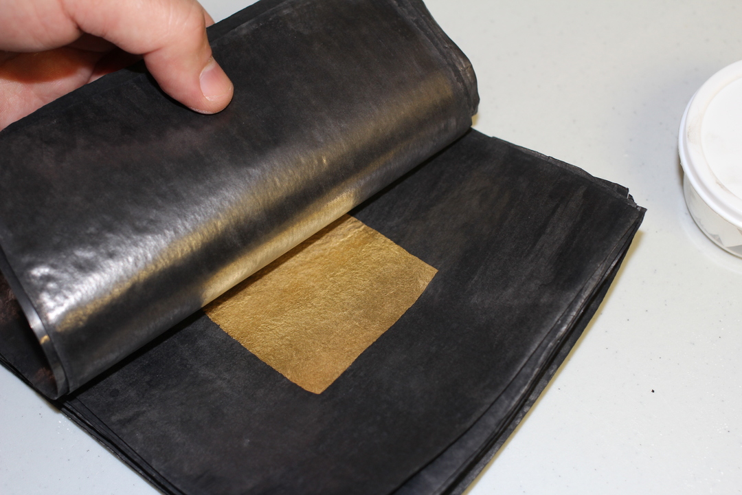 Cut gold sheets are prepared for second beating, put back into black paper.