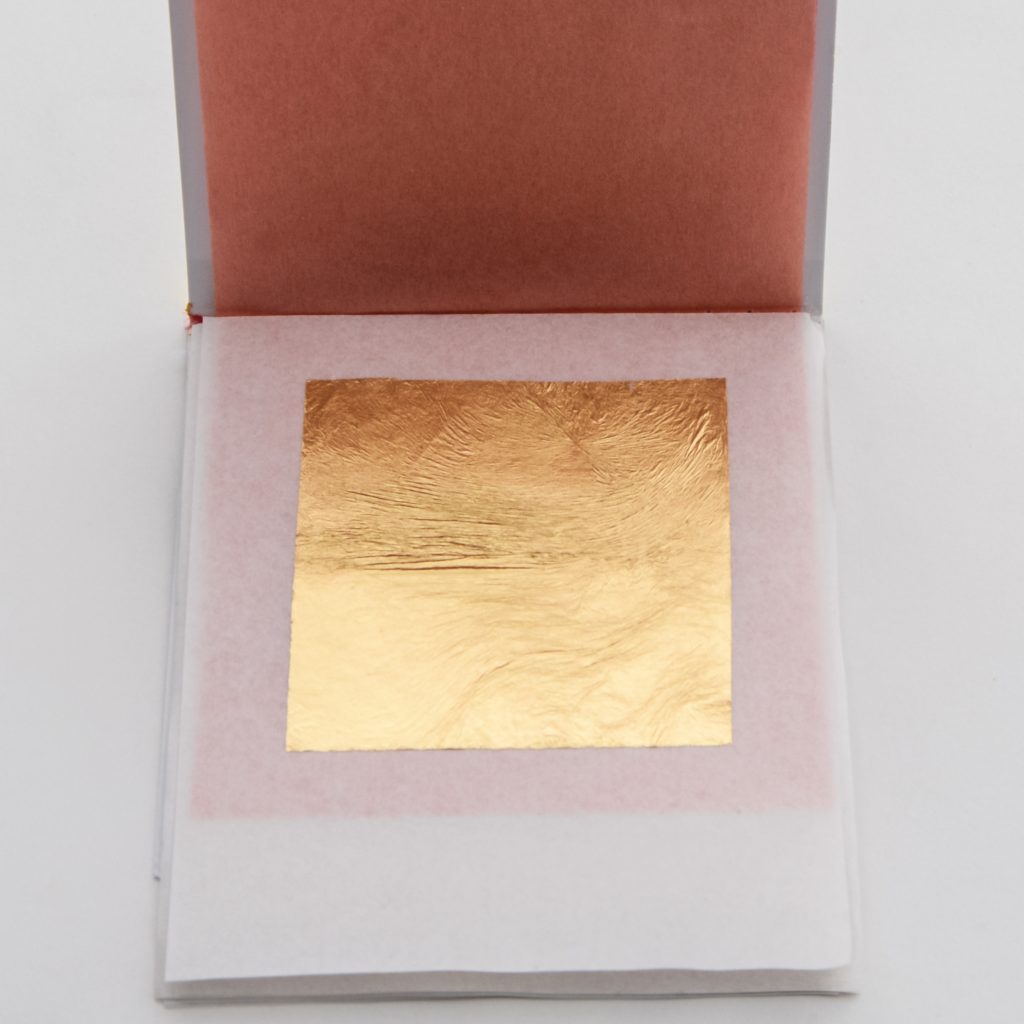 A gold leaf sheet in a booklet.